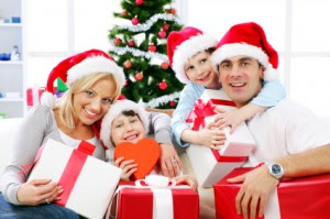 Happy family holding Christmas gift